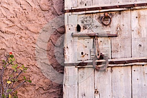 Old vintage massive wooden door with metal locker and handle