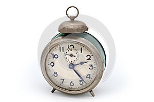 Old vintage mechanical analog alarm clock on a white background