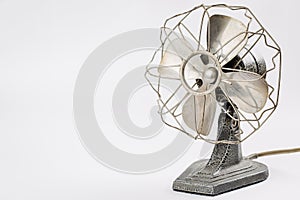 Old vintage metal fan on white