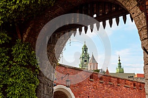 An old vintage metal gate with an archway to the old Zamek Krolewski na Wawelu castle in the center of Krakow