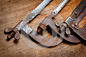 Old vintage metal hacksaws for metal shot on a wooden background