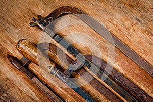 Old vintage metal hacksaws for metal shot on a wooden background