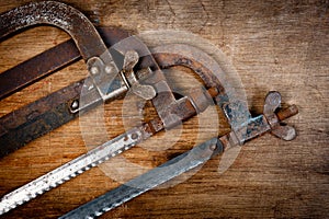 Old vintage metal hacksaws for metal shot on a wooden background