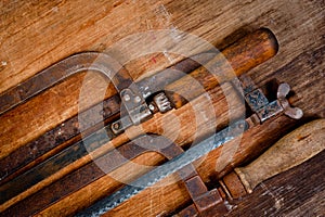 Old vintage metal hacksaws for metal shot on a wooden background