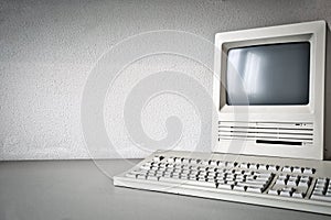 Old vintage monitor and computer on desk, retro workplace with copy space business, technology,internet concept