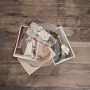 Old vintage monochrome photographs in sepia color are scattered on a wooden table, the concept of genealogy, the memory of