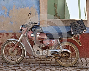Old vintage moped from the 70`s and traditional wall