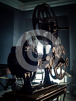 Old vintage movie projector on a dark background