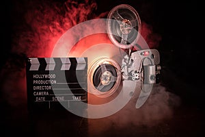 Old vintage movie projector on a dark background with fog and light. Concept of film-making