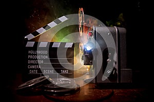 Old vintage movie projector on a dark background with fog and light. Concept of film-making