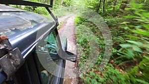 Old vintage off road car riding in muddy road in deep forest of Bosnia and Herzegovina