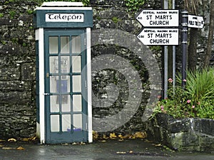 Old vintage phone booth with sign telefon in Cong town, Ireland. Green and white exterior color