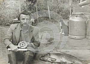 Old vintage photo man with a fishing rod