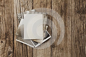 Old vintage photo template mockup on wooden background. Empty retro card, textured paper