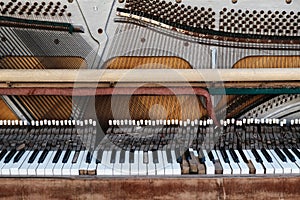 Old vintage piano with the lid off. A dilapidated musical instrument. Close-up. Selective focus