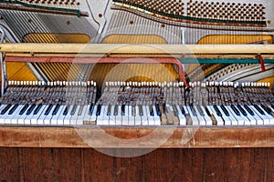 Old vintage piano with the lid off. A dilapidated musical instrument. Close-up. Selective focus