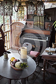 Old vintage pipe organ and table with fruits is