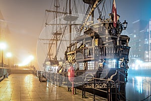 Old vintage pirate ship in the fog