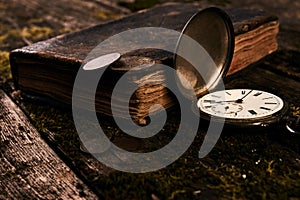 Pocket watch with an old antique bible book and ancient copper c