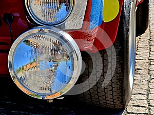 old vintage racing car with additional fog lights. tires of old balloon