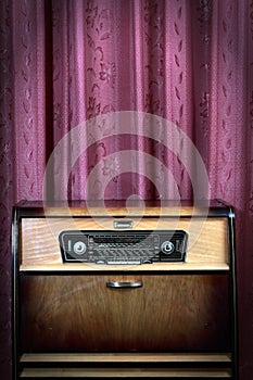 Old vintage radio on red background