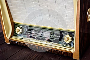 Old vintage radio on a wooden background closeup