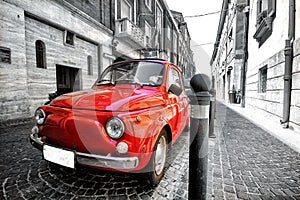 Old vintage red black and white classic parked fiat 500 car in italy rome postcard