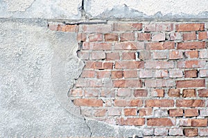 Old vintage red brick wall with gray stucco texture background