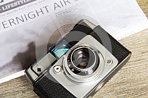 Old vintage retro camera with mocked up newspaper photo