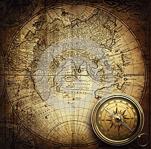 Old vintage retro compass on ancient map background.