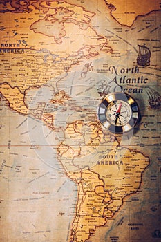 Old vintage retro golden compass on ancient map. Selective focus