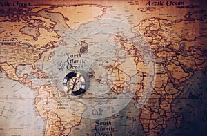 Old vintage retro golden compass on ancient map. Selective focus