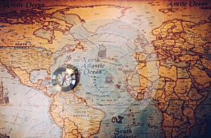 Old vintage retro golden compass on ancient map. Selective focus, shallow depth of field. Concept of world travel, sightseeing and