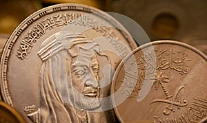 An old vintage retro Saudi Arabia coin at the Era of king Faisal, An Egyptian One 1 LE EGP silver pound coin with the slogan of