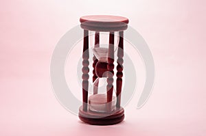 Old vintage retro wooden hourglass on white background