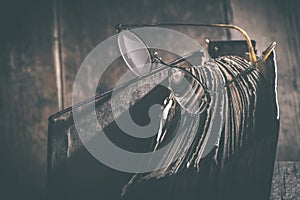 Old vintage round glasses and book