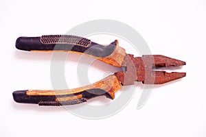 Old vintage rusty iron pliers on a white background