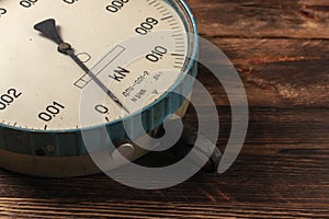 Old vintage scales with arrows, canter on a wooden background