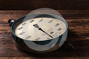 Old vintage scales with arrows, canter on a wooden background