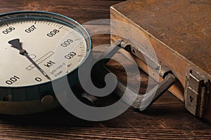 Old vintage scales with arrows, canter on a wooden background