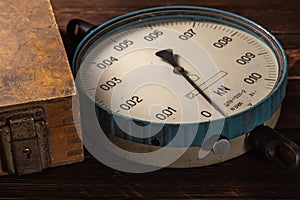 Old vintage scales with arrows, canter on a wooden background