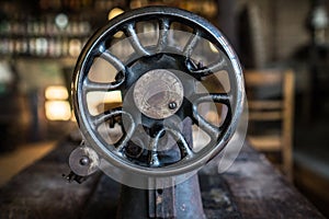 Old VIntage Sewing Machine Pulley on a Village Table