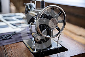 Old vintage sewing machine in the tailor`s workshop