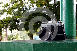 Old and vintage single lens reflex or SLR film camera at an outdoor park