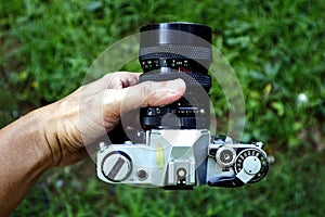 Old and vintage single lens reflex or SLR film camera at an outdoor park