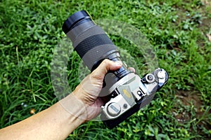 Old and vintage single lens reflex or SLR film camera at an outdoor park