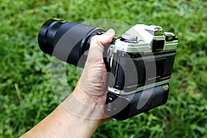 Old and vintage single lens reflex or SLR film camera at an outdoor park