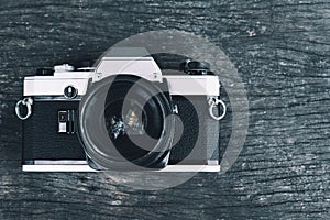 Old vintage SLR Film camera on wood background