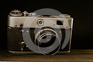 old vintage soviet camera with lens on wooden background