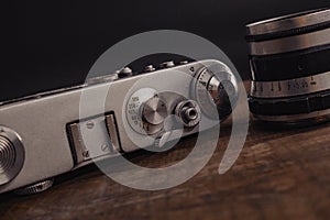 old vintage soviet camera with lens on wooden background